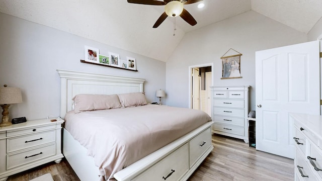 bedroom featuring light wood-type flooring, a ceiling fan, and vaulted ceiling