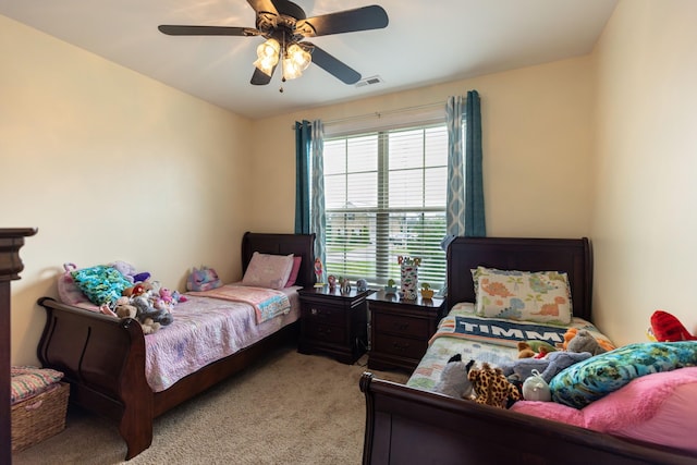 bedroom with light carpet, ceiling fan, and visible vents