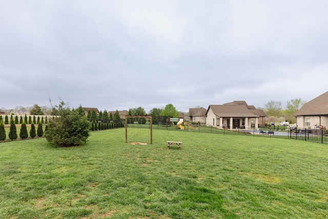 view of yard with a fenced backyard and a playground