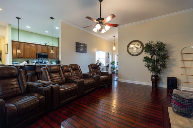 living area featuring hardwood / wood-style floors, crown molding, baseboards, and a ceiling fan