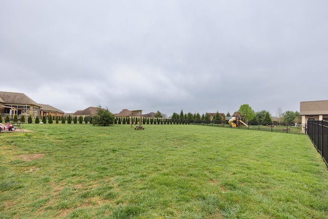 view of yard featuring a fenced backyard and a playground