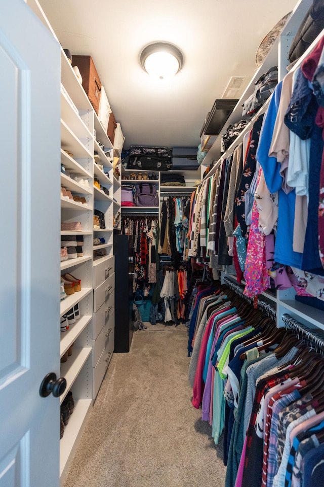 walk in closet featuring carpet flooring