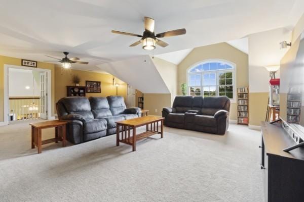 carpeted living area featuring ceiling fan, vaulted ceiling, and baseboards