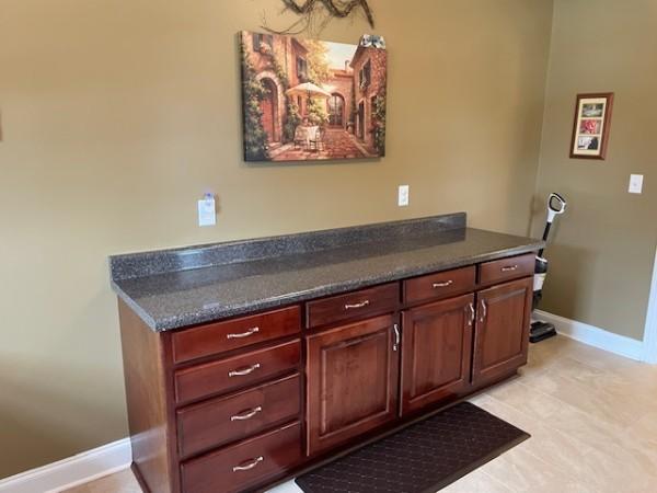 interior space with baseboards and tile patterned flooring
