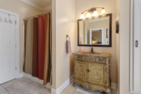 full bath featuring tile patterned floors, vanity, and ornamental molding