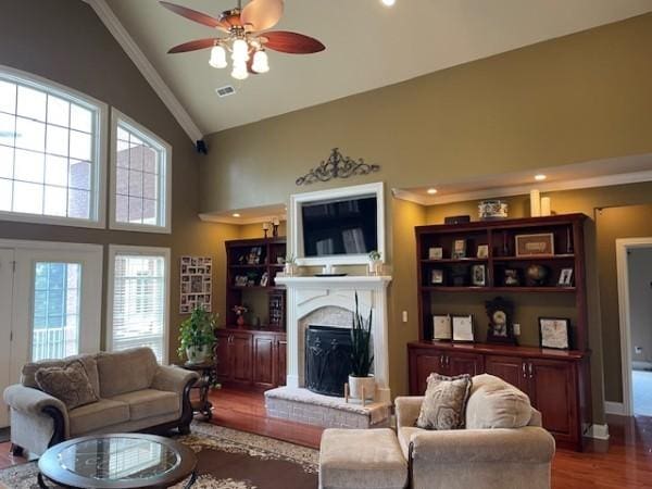 living room featuring recessed lighting, a brick fireplace, wood finished floors, ceiling fan, and high vaulted ceiling