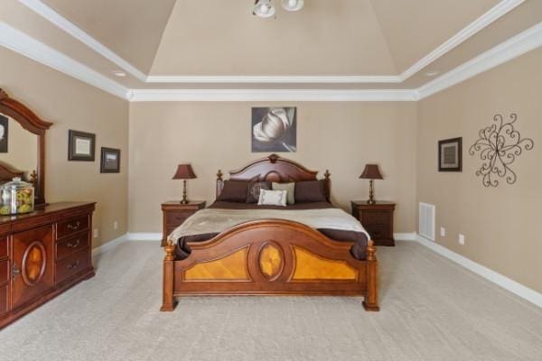 bedroom with lofted ceiling, ornamental molding, a raised ceiling, and light colored carpet