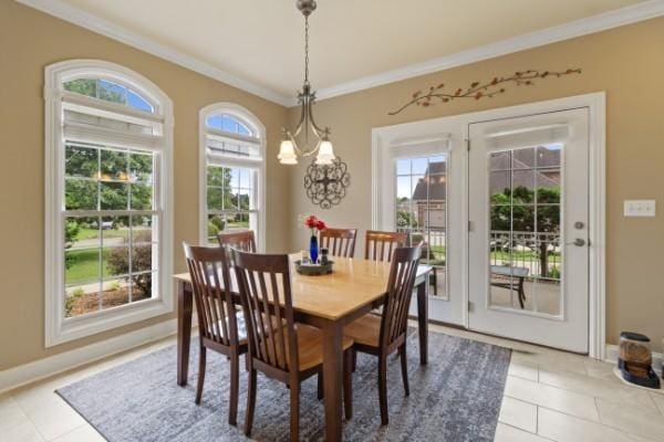 dining space featuring crown molding, baseboards, and light tile patterned floors