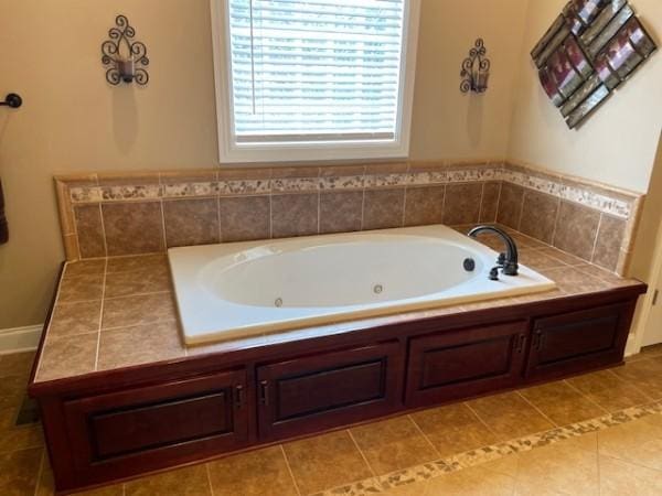full bathroom featuring tile patterned floors and a whirlpool tub