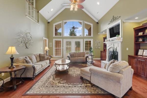 living room featuring recessed lighting, wood finished floors, a fireplace, high vaulted ceiling, and ceiling fan