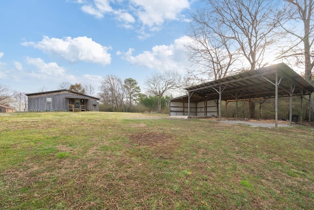 view of yard with an outbuilding, a carport, and a pole building