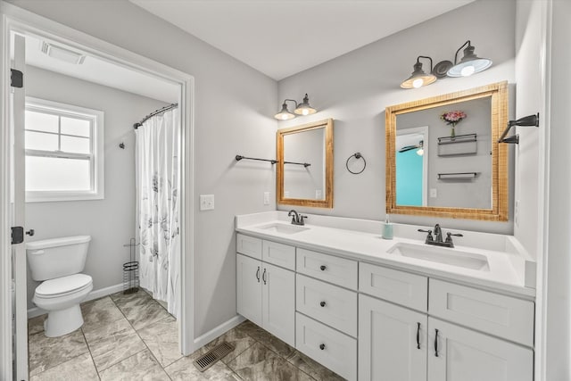 full bathroom featuring toilet, visible vents, and a sink