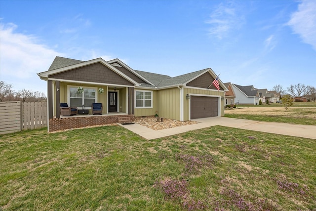 view of front of house with fence, driveway, covered porch, a front lawn, and a garage