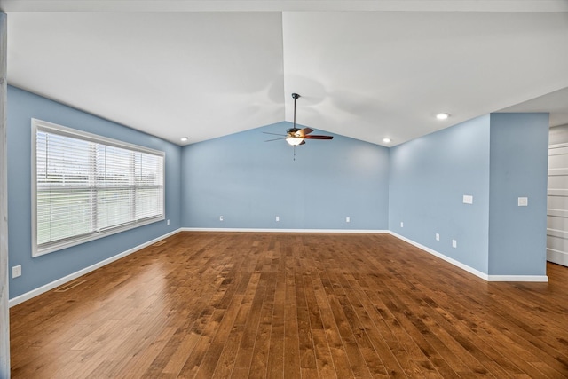 spare room with visible vents, lofted ceiling, ceiling fan, and wood finished floors
