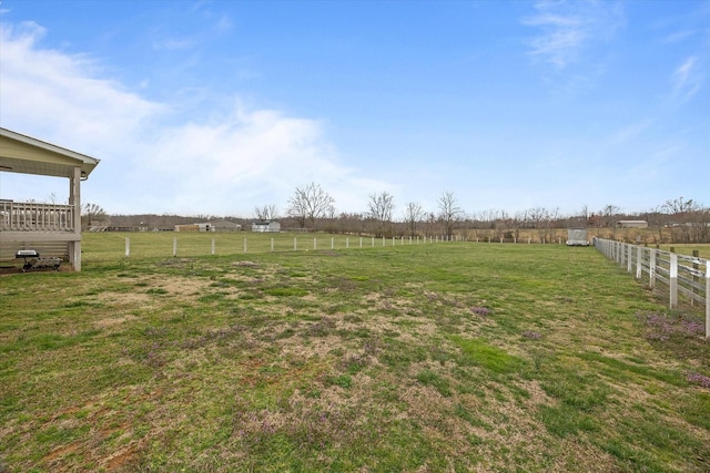 view of yard featuring a rural view and fence