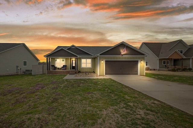 view of front facade with board and batten siding, a front lawn, a porch, concrete driveway, and a garage