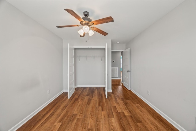unfurnished bedroom featuring a closet, ceiling fan, baseboards, and wood finished floors