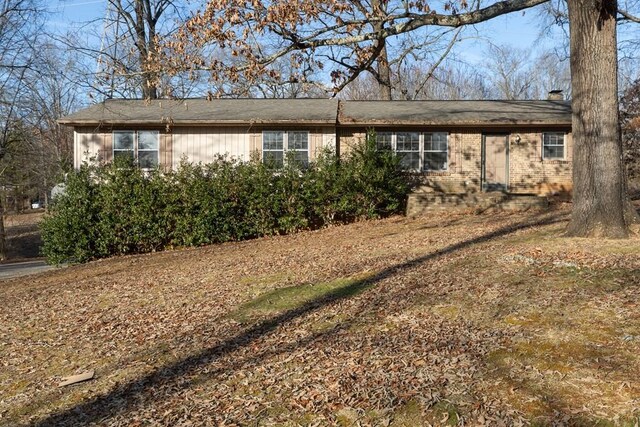 ranch-style house with brick siding and a chimney