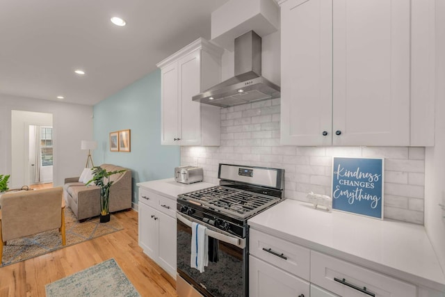 4009B Indiana Ave, Nashville, TN 37209 - kitchen featuring recessed lighting, white cabinets, gas range, wall chimney range hood, and light wood-type flooring