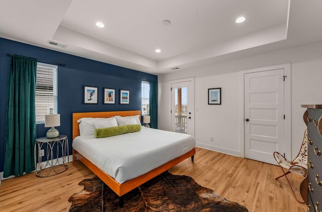 4009B Indiana Ave, Nashville, TN 37209 - bedroom with access to exterior, a tray ceiling, and light wood-style floors