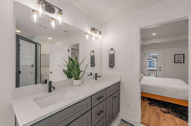 4009B Indiana Ave, Nashville, TN 37209 - ensuite bathroom with double vanity, visible vents, a shower stall, and a sink