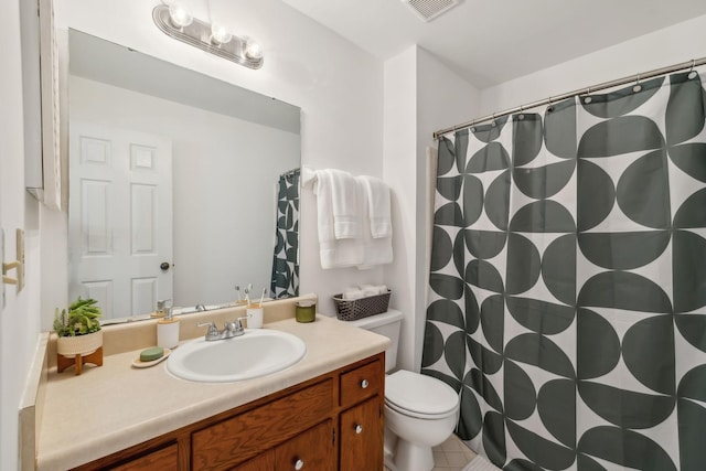 bathroom with vanity, toilet, and visible vents