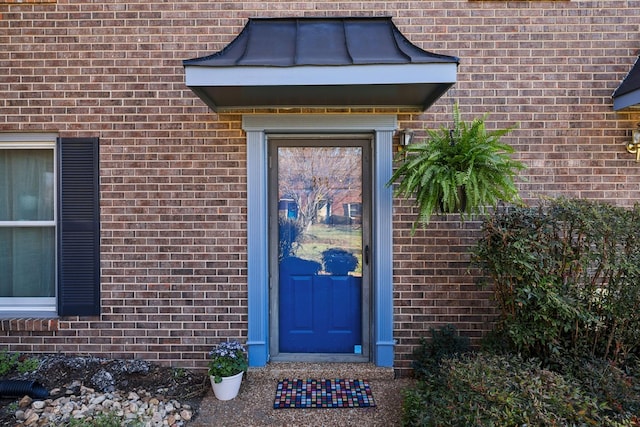 property entrance with brick siding