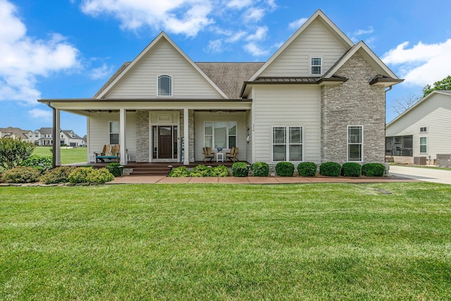 214 River Watch Way, Winchester, TN 37398 - view of front facade featuring stone siding, a front yard, and covered porch