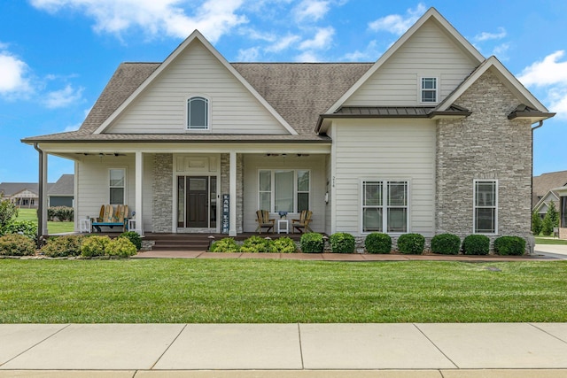 214 River Watch Way, Winchester, TN 37398 - view of front of house with stone siding, roof with shingles, a front lawn, and a porch