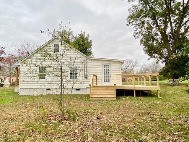 back of house featuring a wooden deck, a yard, and crawl space