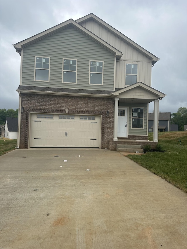 150 Cardinal Crk, Clarksville, TN 37040 - craftsman inspired home with brick siding, an attached garage, concrete driveway, and covered porch