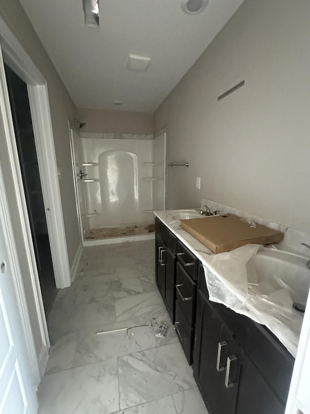 150 Cardinal Crk, Clarksville, TN 37040 - bathroom with a shower, marble look tiles, double vanity, and baseboards