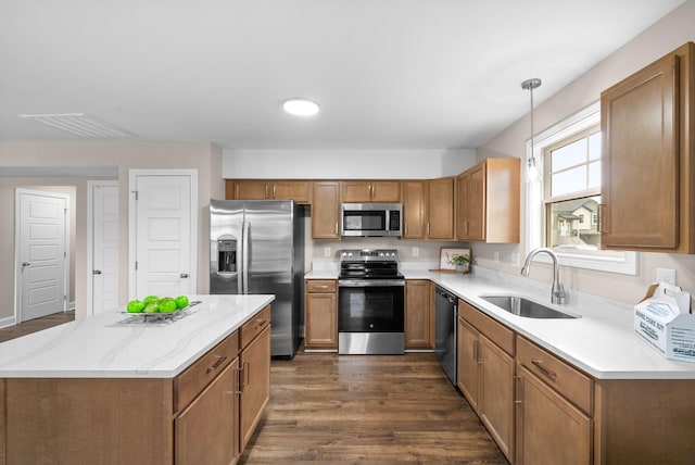 150 Cardinal Crk, Clarksville, TN 37040 - kitchen featuring appliances with stainless steel finishes, a sink, dark wood-style flooring, and brown cabinets