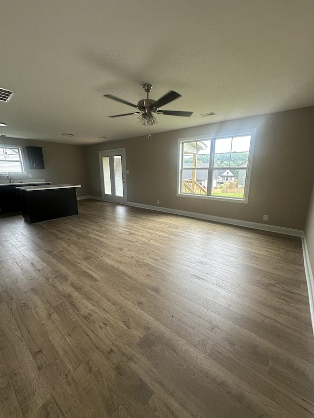 150 Cardinal Crk, Clarksville, TN 37040 - unfurnished living room with healthy amount of natural light and dark wood-style flooring