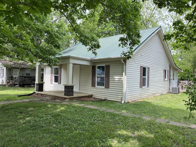 807 Meadowlane Dr, Lebanon, TN 37087 - rear view of house with covered porch, central air condition unit, a yard, and metal roof