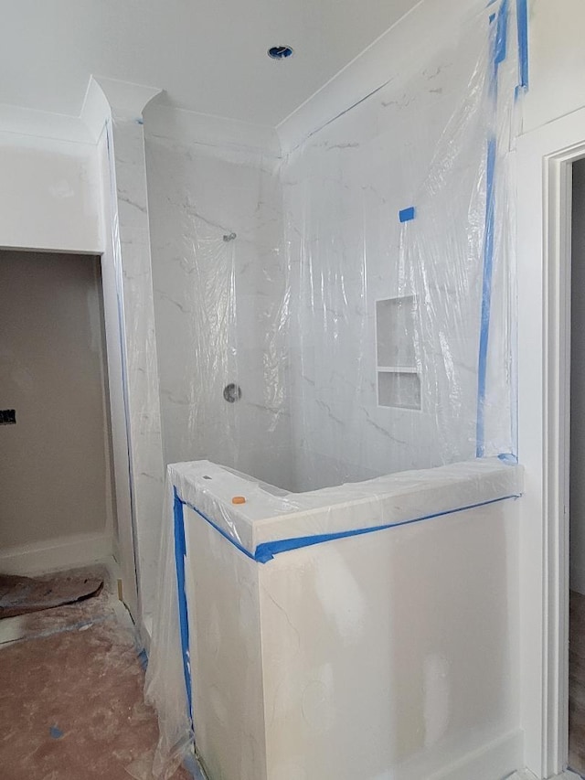 bathroom with a marble finish shower