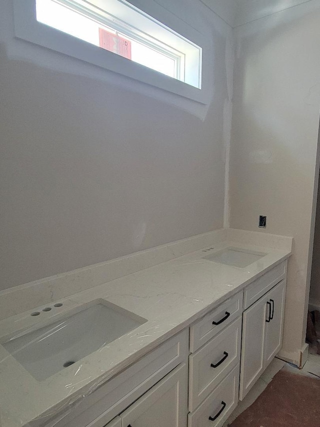bathroom featuring double vanity and a sink