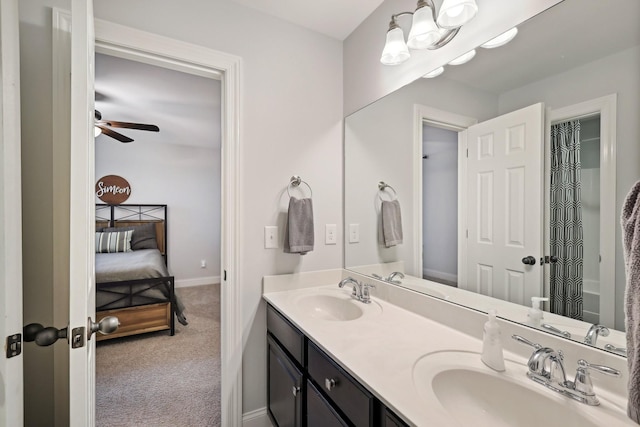 ensuite bathroom featuring a sink, double vanity, ensuite bath, and a ceiling fan