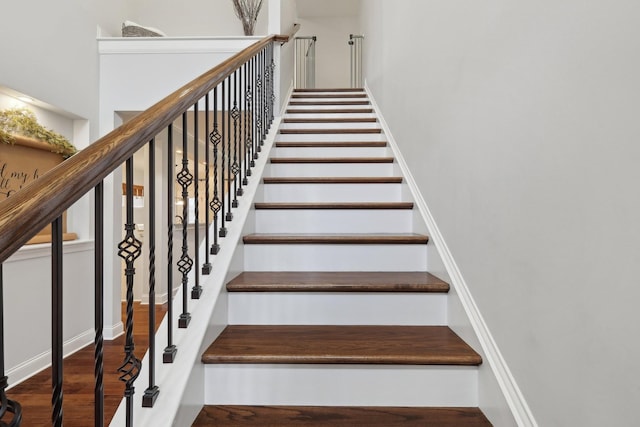 stairs featuring wood finished floors