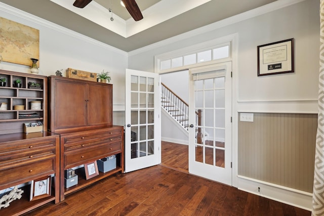 office with a tray ceiling, ornamental molding, french doors, a ceiling fan, and dark wood-style flooring