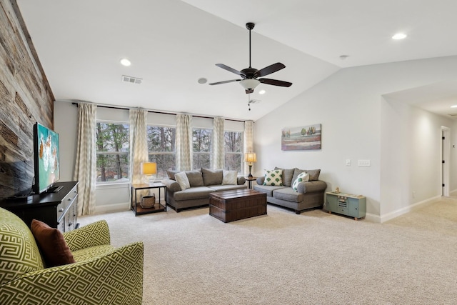 living area featuring visible vents, baseboards, vaulted ceiling, carpet flooring, and a ceiling fan