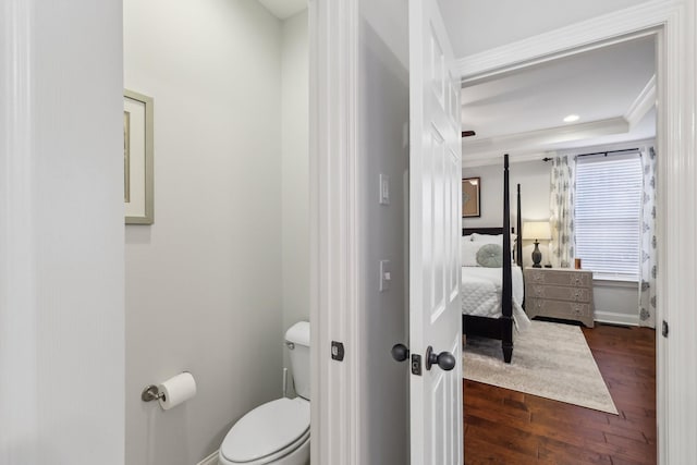 ensuite bathroom with crown molding, baseboards, toilet, ensuite bathroom, and wood finished floors