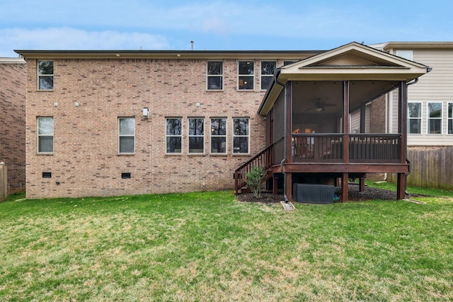back of property featuring a lawn, brick siding, and a sunroom