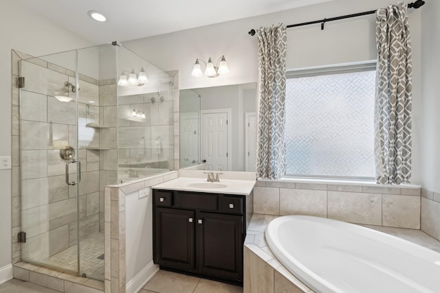 full bathroom featuring a garden tub, a stall shower, vanity, and tile patterned flooring