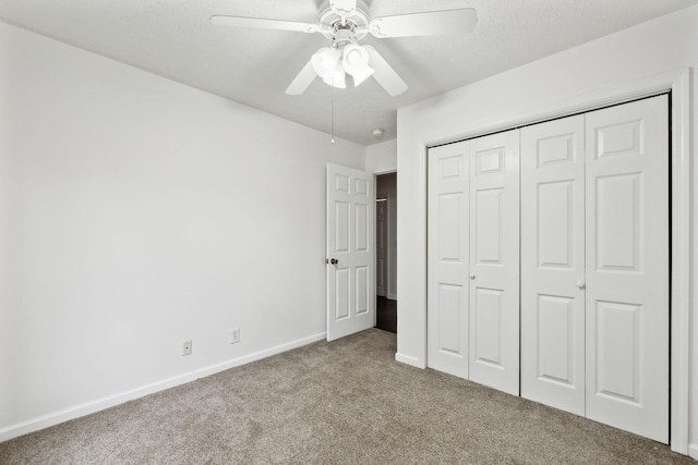 unfurnished bedroom featuring carpet flooring, baseboards, a closet, and ceiling fan