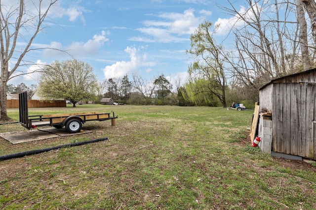 view of yard featuring a storage unit and an outbuilding