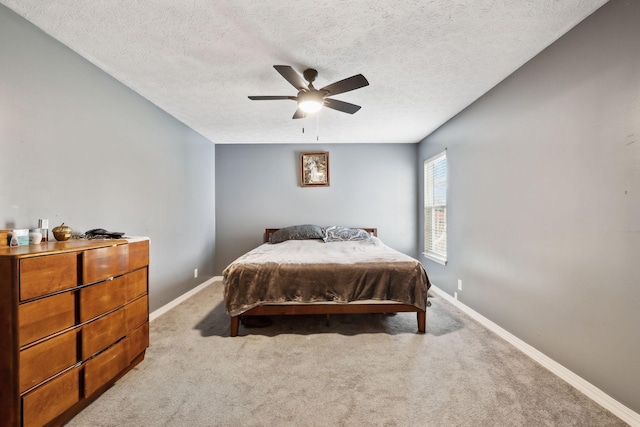 bedroom with baseboards, carpet floors, and a textured ceiling