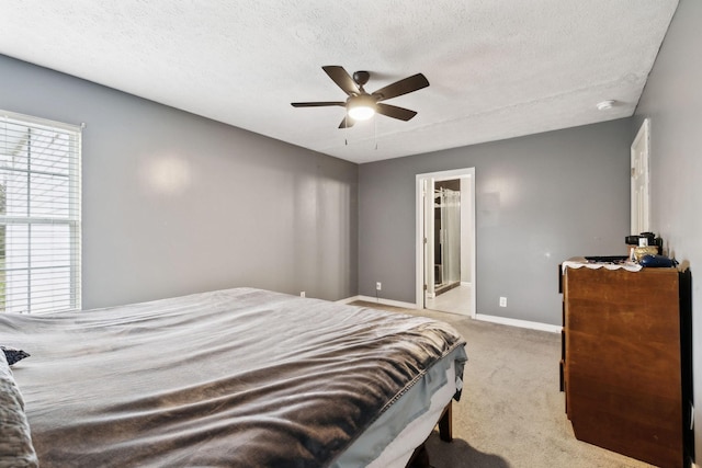 bedroom with ceiling fan, carpet flooring, baseboards, and a textured ceiling