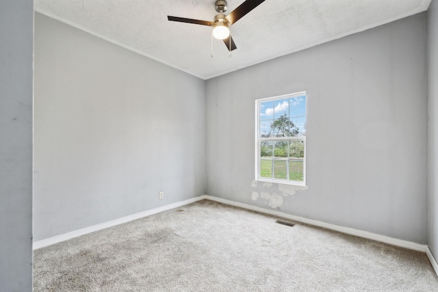 unfurnished room featuring a ceiling fan, baseboards, carpet floors, and a textured ceiling