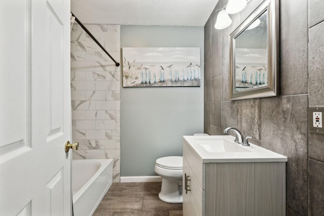full bath with baseboards, toilet, vanity, shower / bathing tub combination, and a textured ceiling